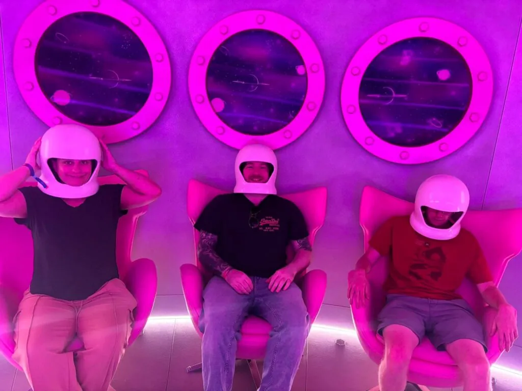 Three people dressed in space suits at Barbie Experience in Amsterdam
